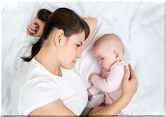 mother in bed with baby