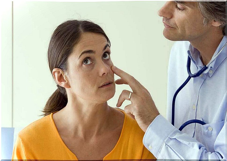 a doctor examines a woman's eyes