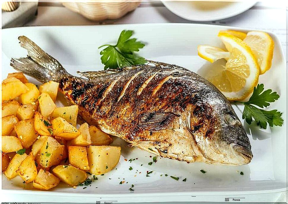 Delicious sea bass with potatoes and onions