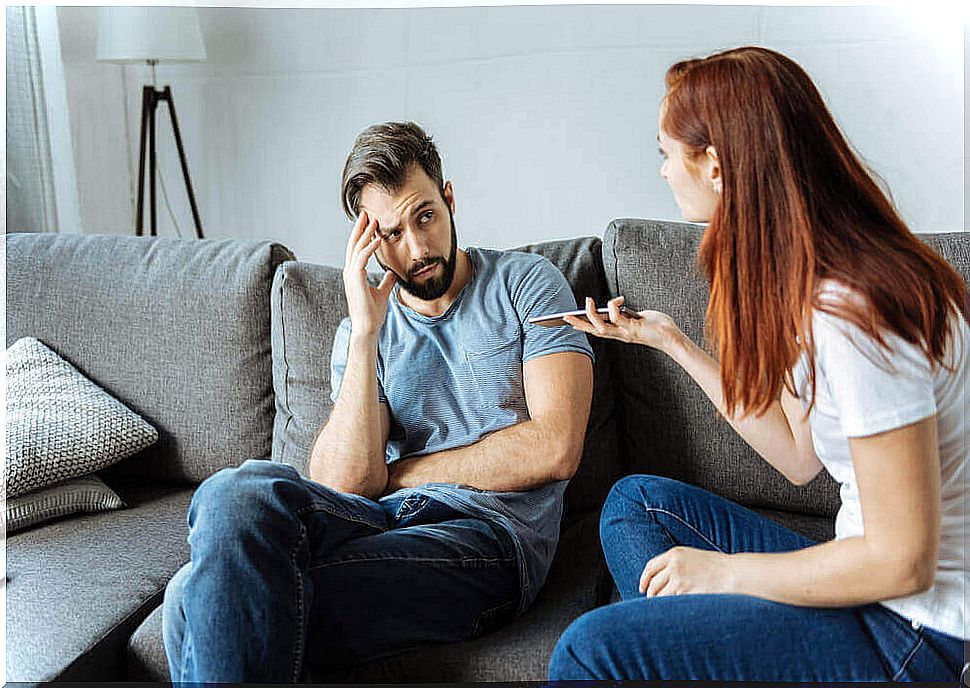 the couple is chatting on the couch