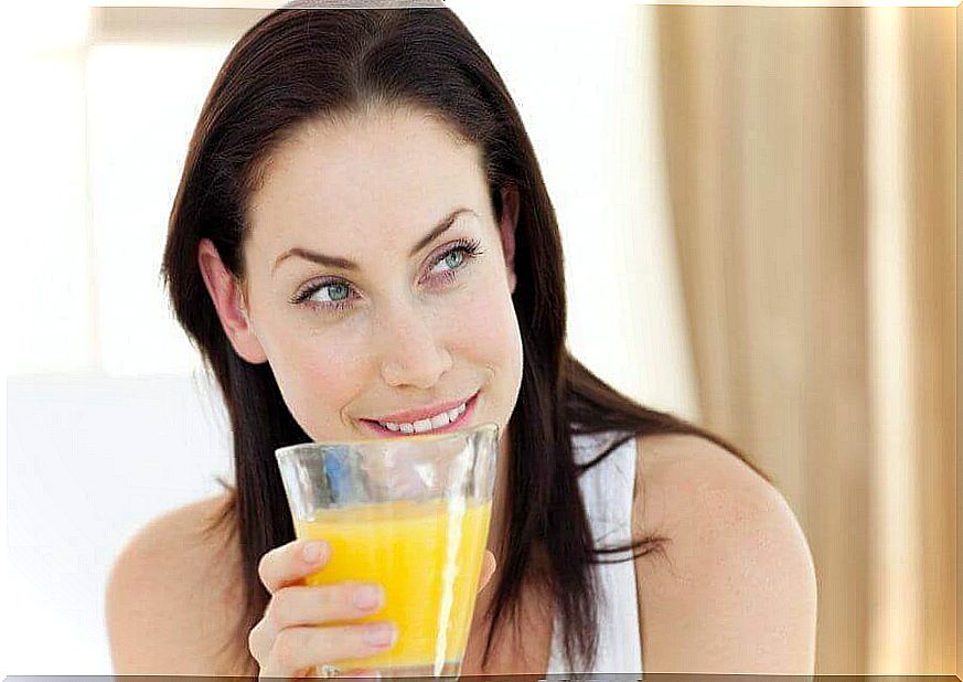 Woman drinking pineapple juice.