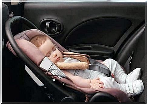 the baby is sleeping in a car seat